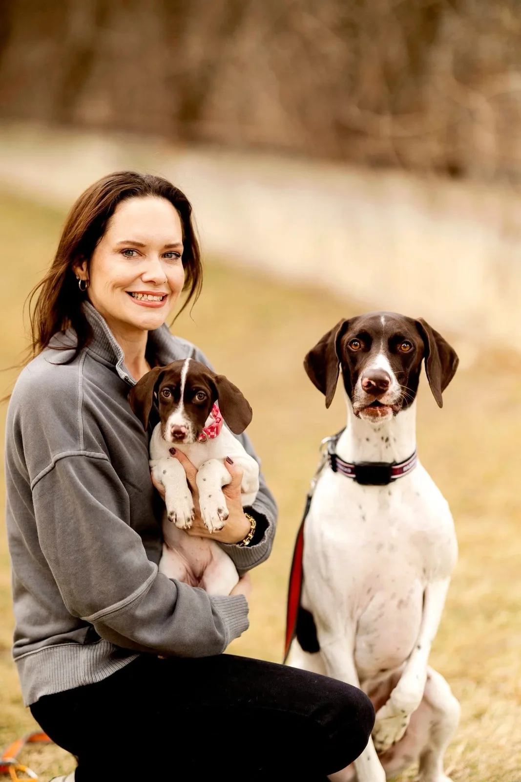 Diedre smiling with Lovie Rae in her arms and Rowdy Ray beside her
